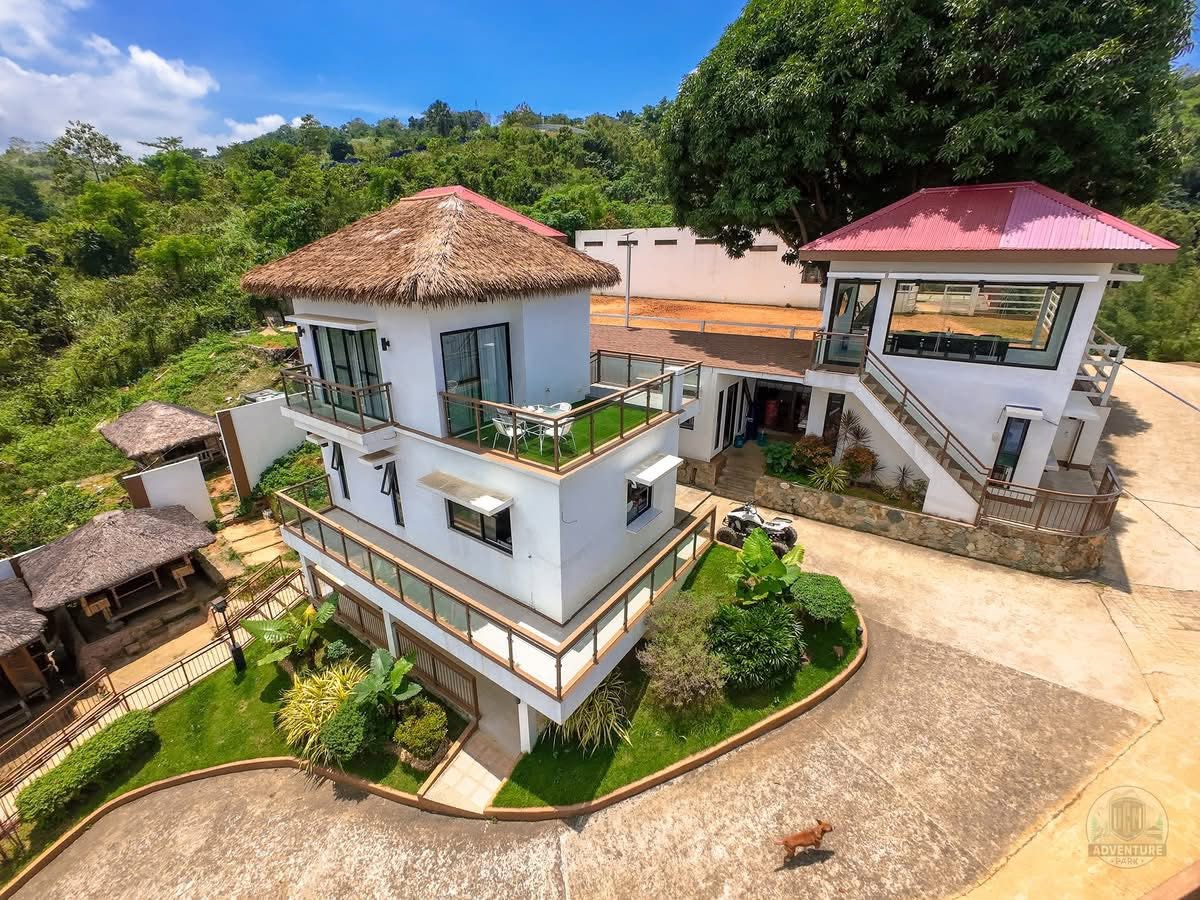 Villa balcony with a spacious wooden terrace surrounded by nature