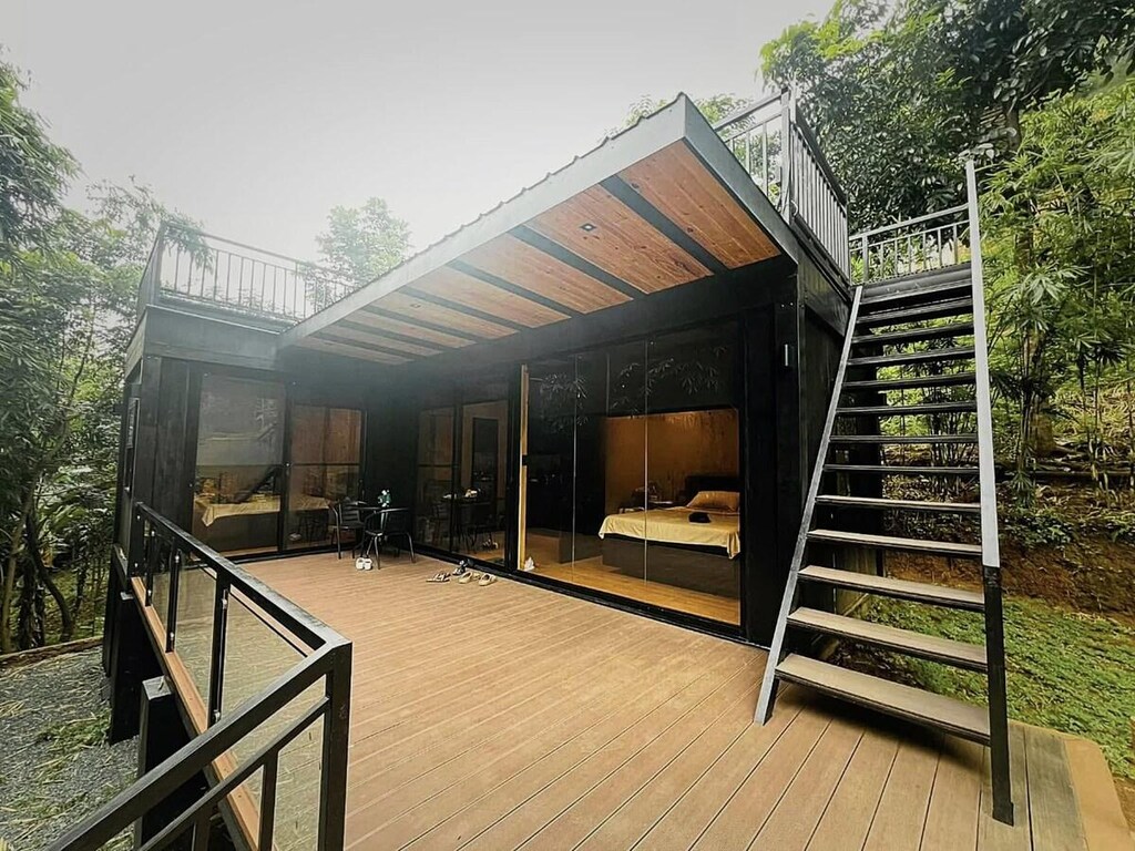 Wooden cabin tucked among tall forest trees