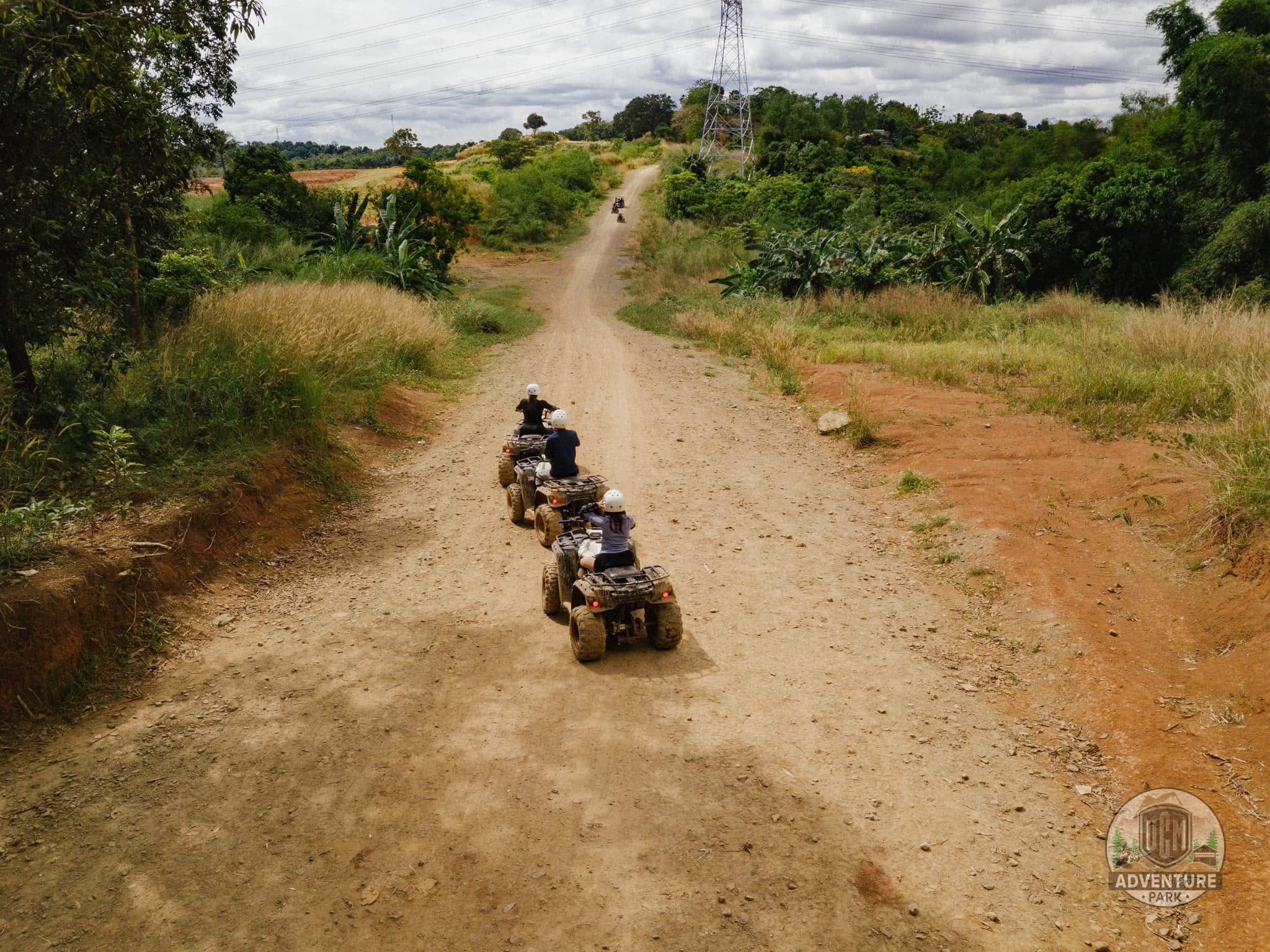 Two riders exploring a rugged nature trail on an ATV
