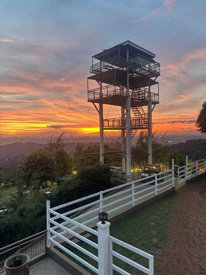 Mountain observation tower overlooking a green mountain landscape