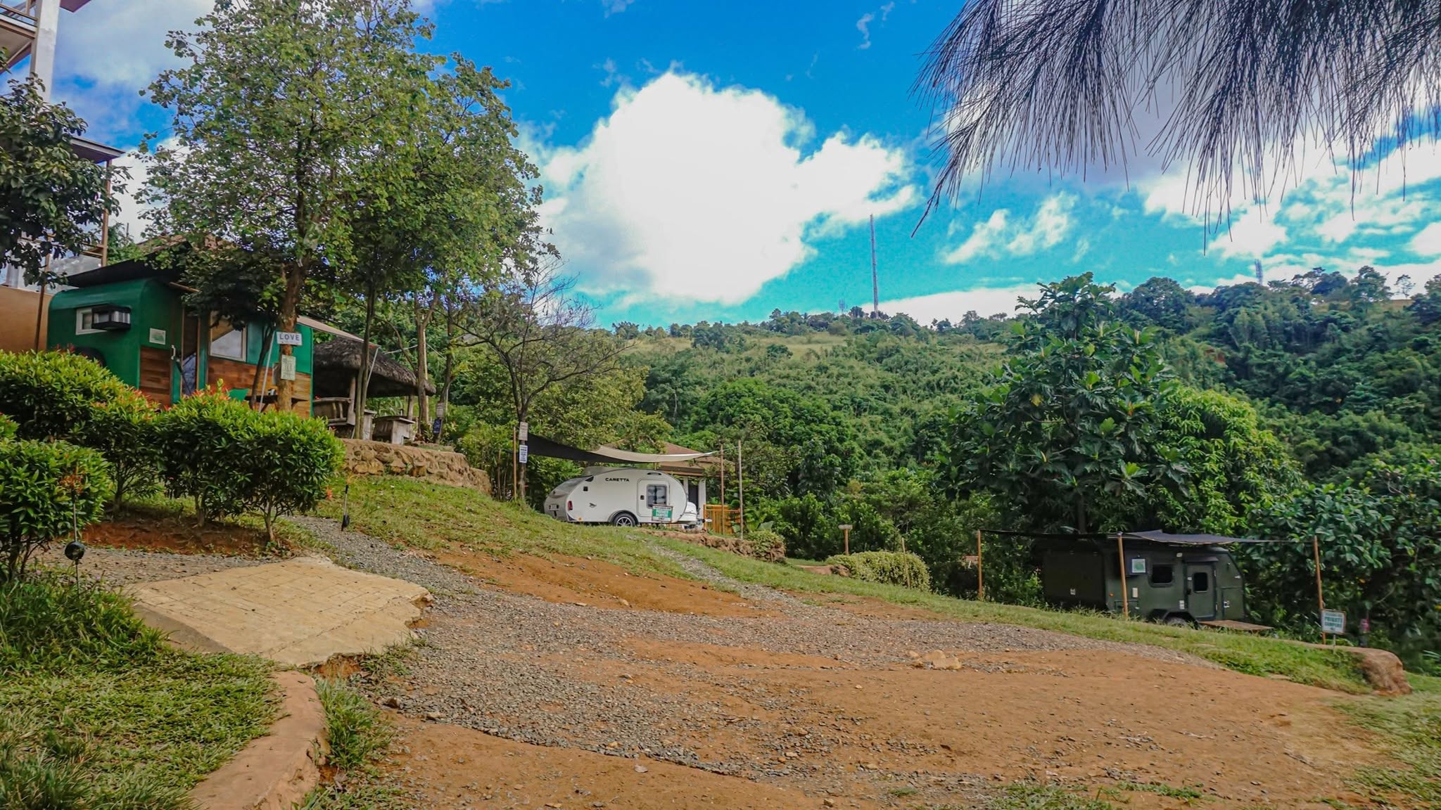 Pathways and buildings surrounded by greenery inside UCM Adventure Park